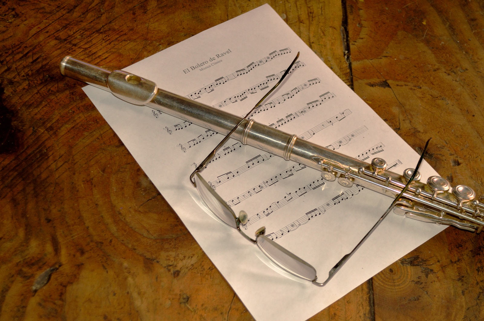 flute and eyeglasses on paper